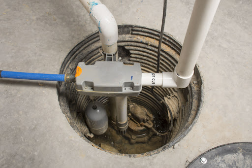 A sump pump installed in a concrete floor.